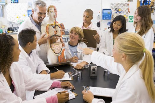 Students in biology class with teacher 