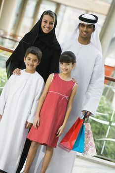 Family standing in mall smiling (selective focus) 