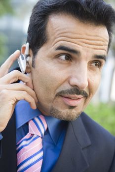 Businessman outdoors wearing headset (selective focus) 