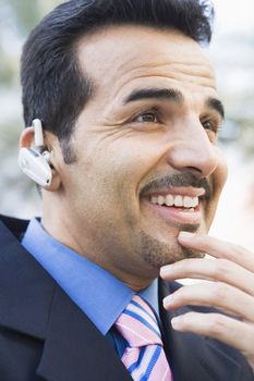 Businessman outdoors wearing headset (selective focus) 