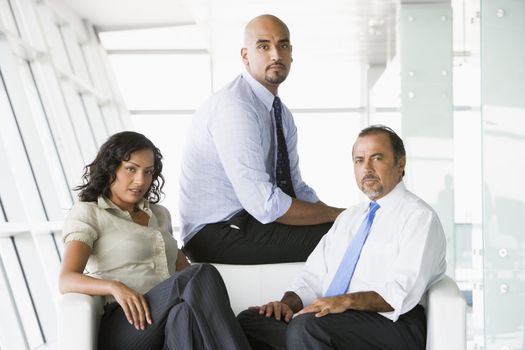 Three businesspeople sitting indoors (high key/selective focus)