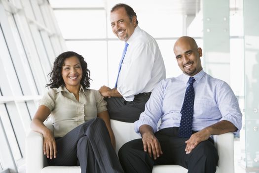 Three businesspeople sitting indoors (high key/selective focus)