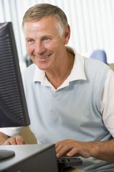 Man sitting at a computer terminal (high key)