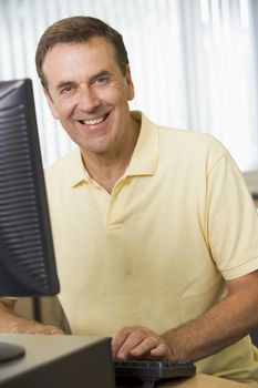 Man sitting at a computer terminal (high key)