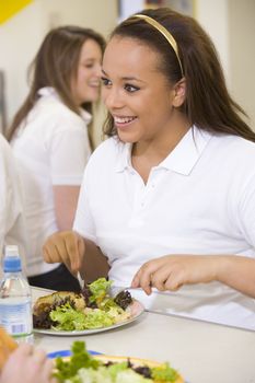 Student having lunch in dining hall 
