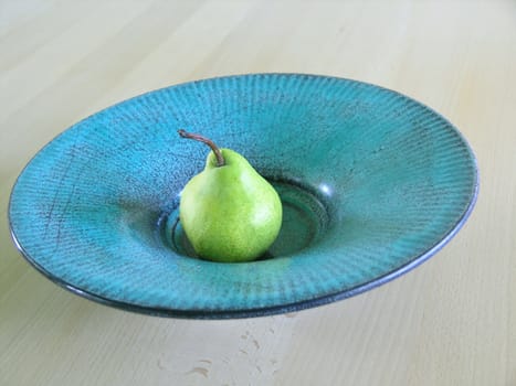 sweet, fresh, green pear on plate