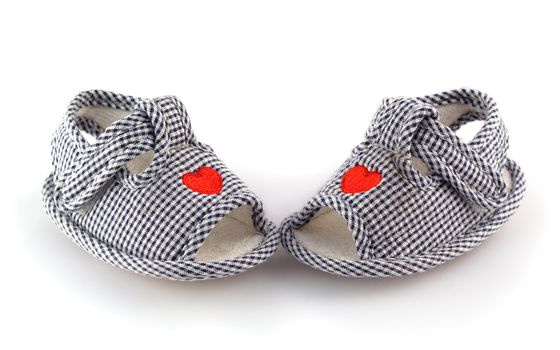 Baby shoes on the white with red hearts