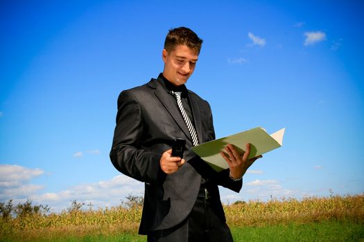 Businessman with folder and cellphone
