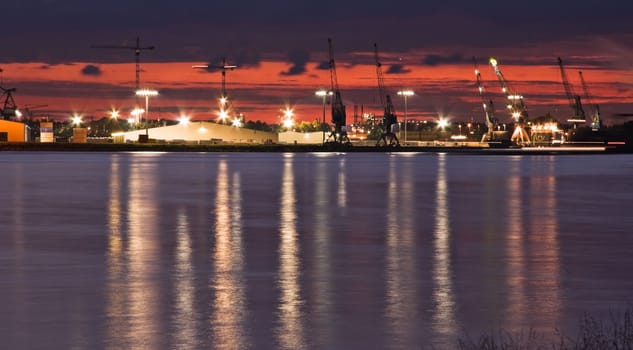 Container port with cranes at the riverside 