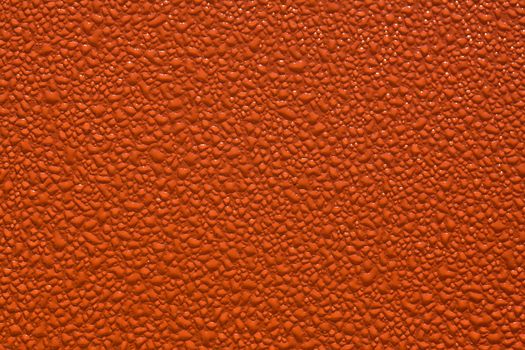 texture series: water drop on orange painted surface