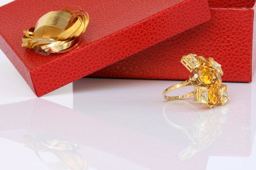 open red gift box and gold ring with reflection