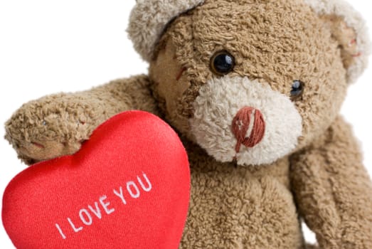 Teddy bear with red heart - "I love you" inscription on it.