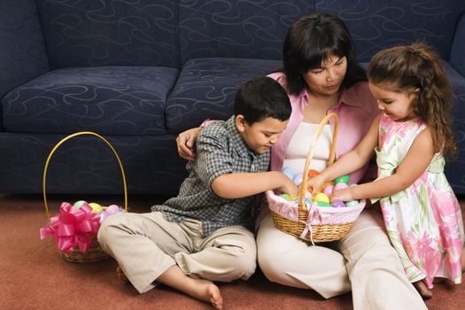 Family sitting on floor with Easter baskets.