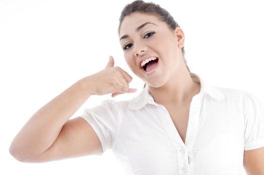 beautiful young female making a phone call hand gesture on an isolated white background