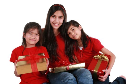 Three sisters holding presents