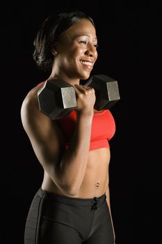 Woman holding dumbbell.