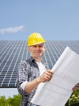 electrician standing near solar panels