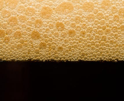 foam from dark beer with bubbles