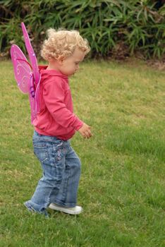 Blondie litlle girl in a butterfly costume wings