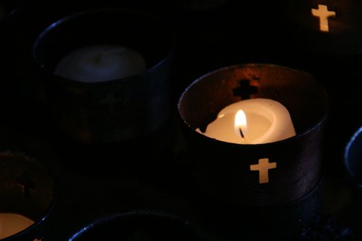 Candles burning in religious cups