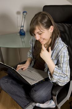 Young woman looks at her notebook