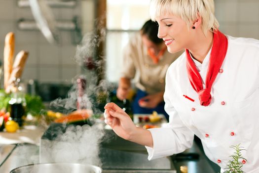 Chefs in a restaurant or hotel kitchen cooking