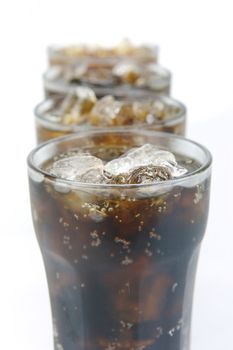 Glasses of cola isolated against a white background