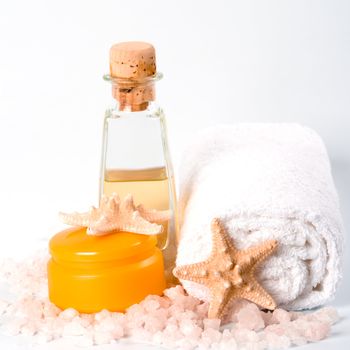 spa products: sea salt, towel, facial creme oil and stars