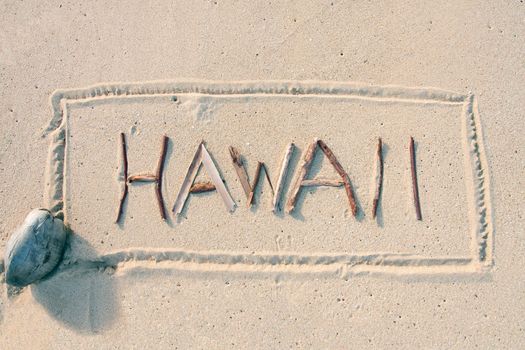 Hawaii written with sticks on the sand