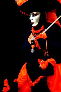 A masked woman on black background, at the Venice Carniva