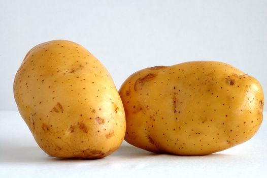 Two ripen potatoes put together side by side