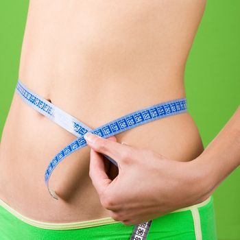 woman measuring her slim body 