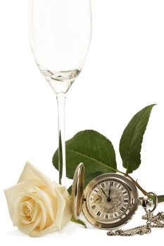 creamy rose with a old pocket watch and a empty champagne glass