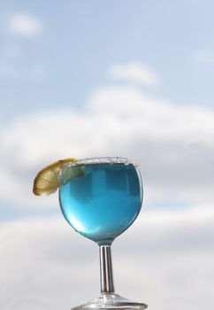 The glass with a cocktail at a window