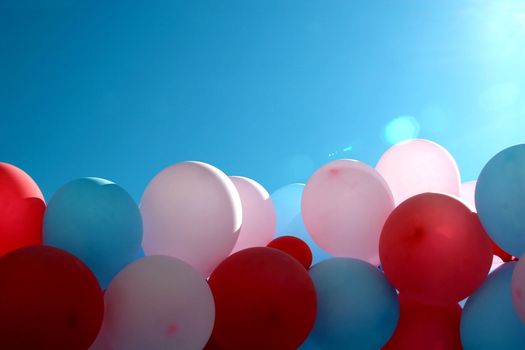 Multi-coloured balloons on a background of the blue sky