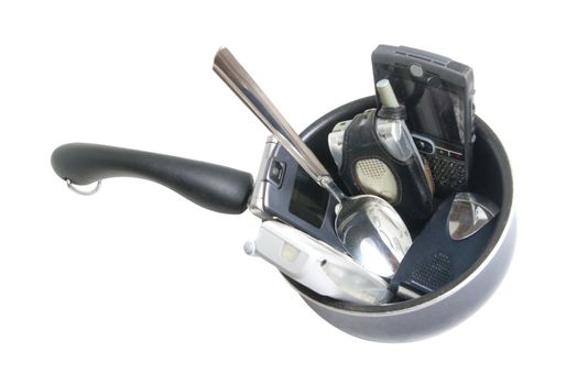 Sauce pan with various cells phone and serving spoon, isolated on white background.