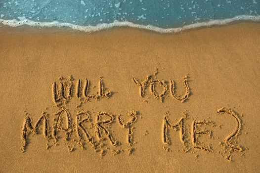 will you marry me written in sand, cyan water