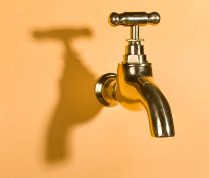 faucet in orange wall