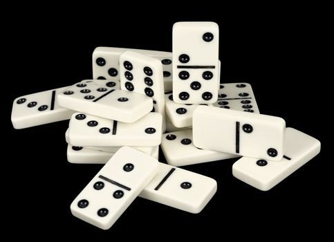 Heap of bones of dominoes on a black