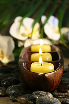 Spa setting with pebbles, candles for wellness concept 
