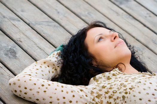 woman lying on wooden floor