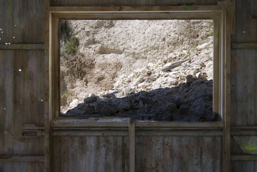 Mined Diatomaceous Earth falling through the Window of an abando