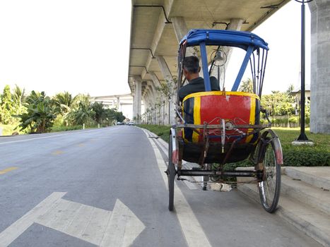 Trishaw under a bridge