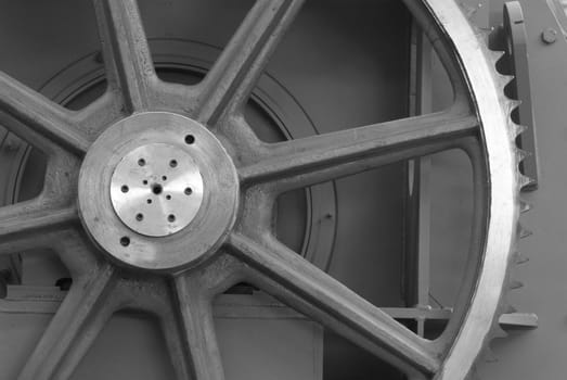 Detail of large, cast iron cogwheel. Black and white photo