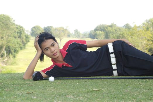 Female golf player resting