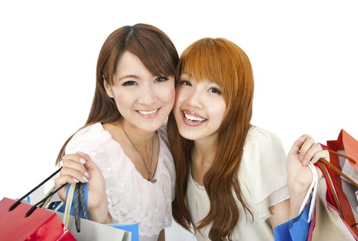 happy young girls standing together with shopping bags