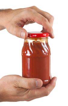jar tomato paste in hand
