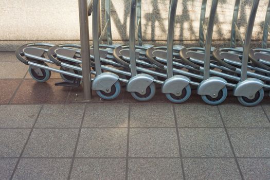 Line of empty luggage carts ready to be used.