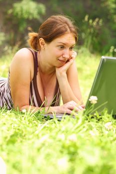 Young woman using her laptop outdoors.