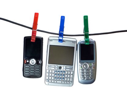 Three mobile phones on a clothes line, hanging with clothes-peg